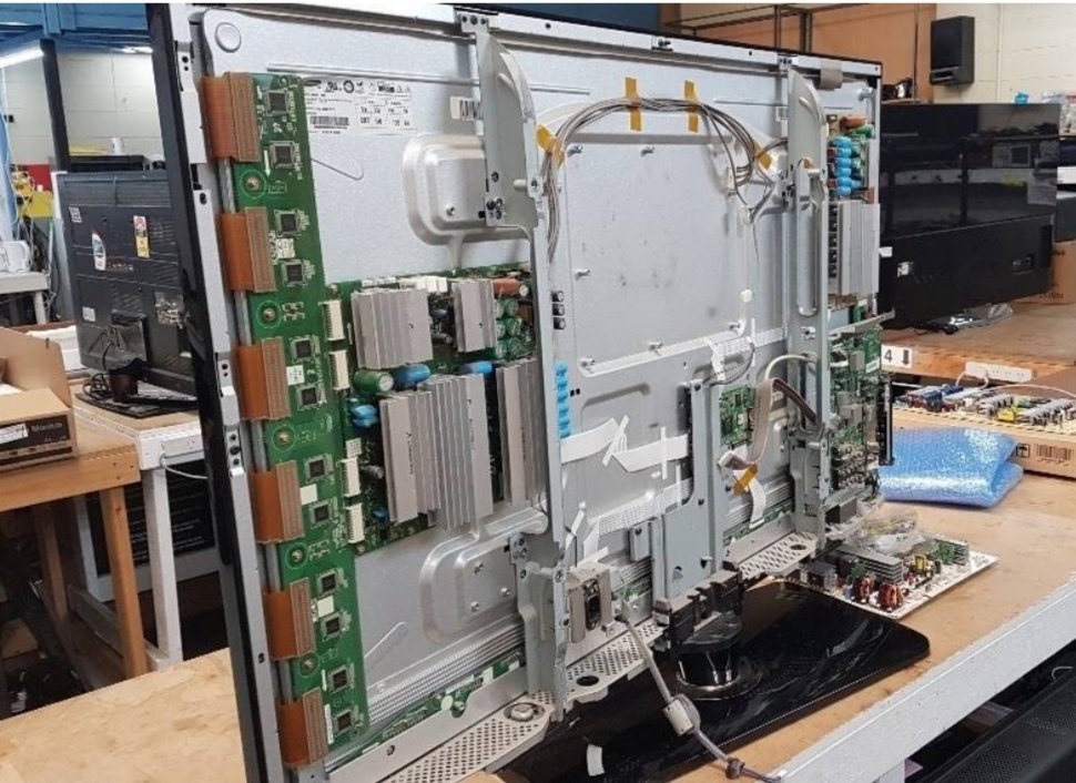 Curved and smart TV repair service with panel opened at workshop